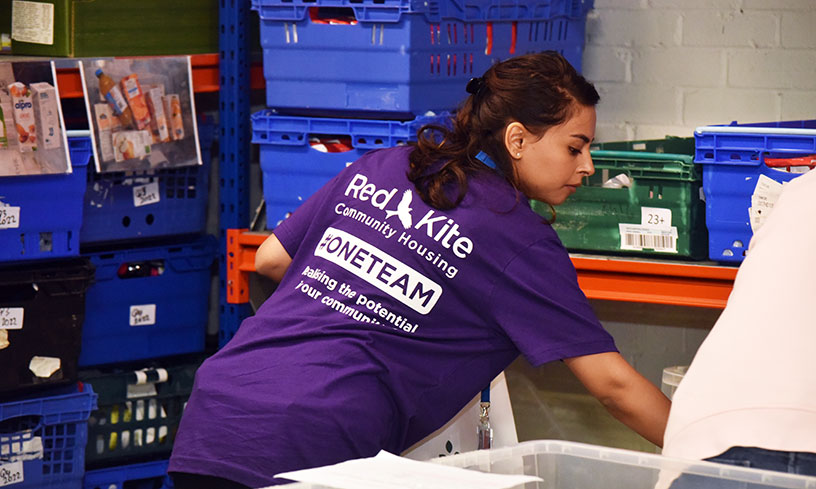 A Red Kite member of staff volunteering at a food bank