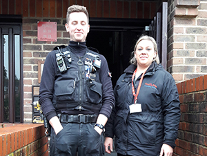 A police officer and Red Kite staff standing outside McLellan Place