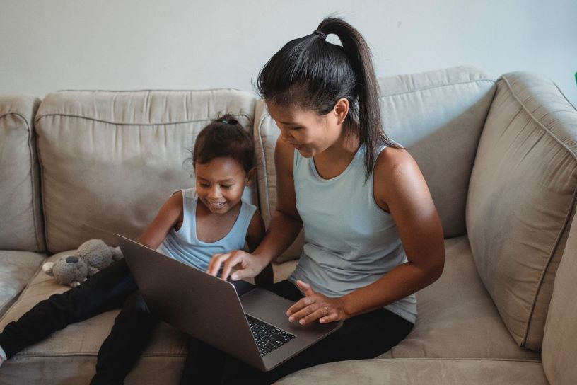 Adult and child using laptop