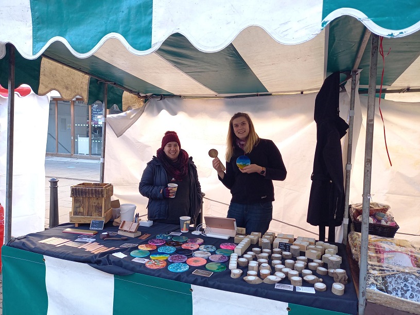 Two stall holders showing their items available to buy