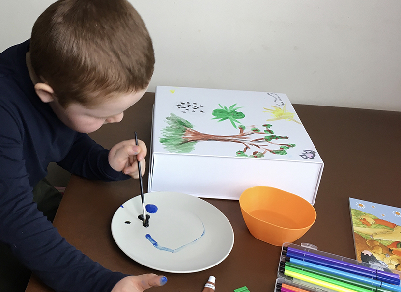 Memories Box - A boy painting on a table