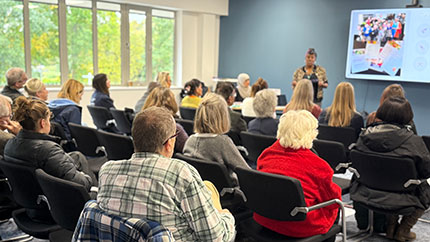 Attendees listening to a presentation at the networking event