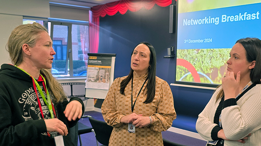 A representative of Gods of War talking to Red Kite staff at the Networking Event