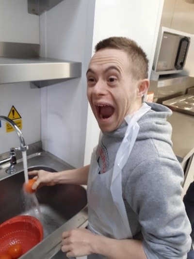 A happy boy using the sink at the new Hilltop kitchen