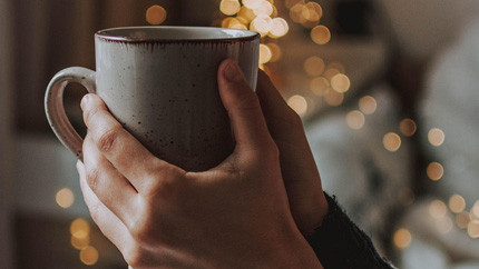 Hands holding a mug