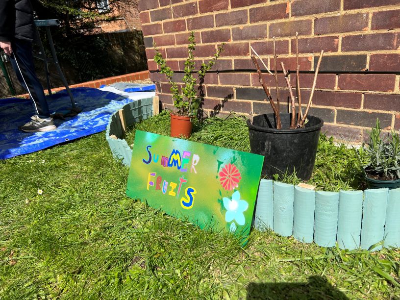 A spray-painted sign saying 'Summer Fruits'