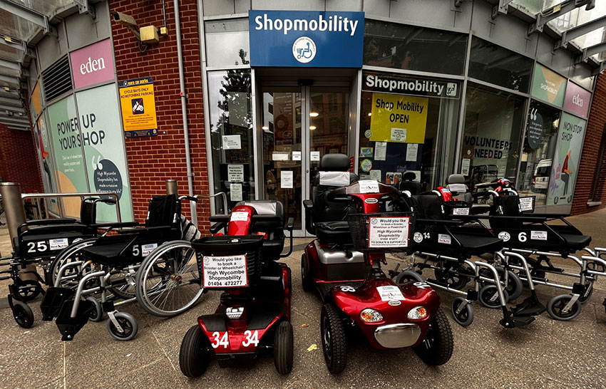 A collection of mobility scooters and wheelchairs outside Shopmobility High Wycombe in the Eden shopping centre, High Wycombe