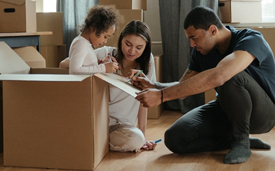 A family packing moving home boxes