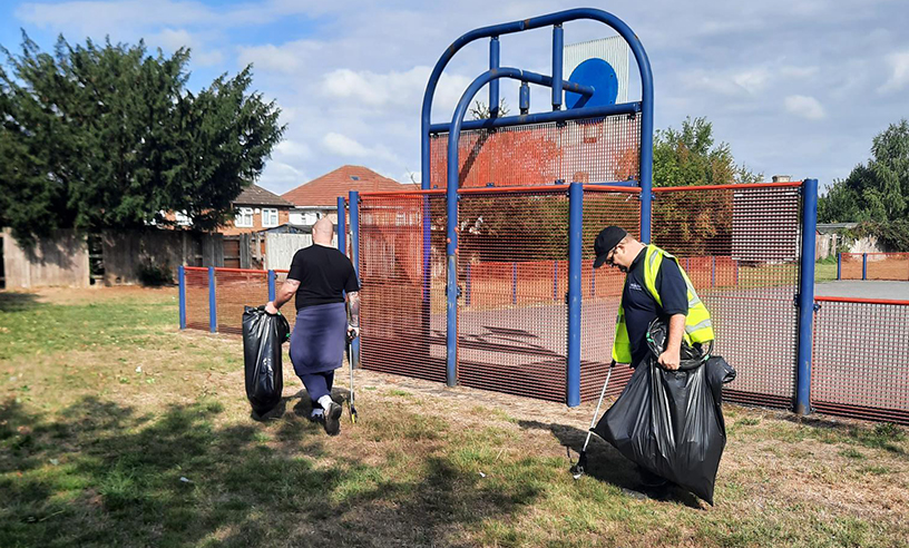 Two litter pickers at a Castlefield children's park