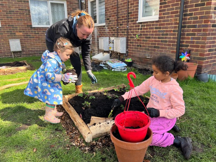 Children planting strawberries