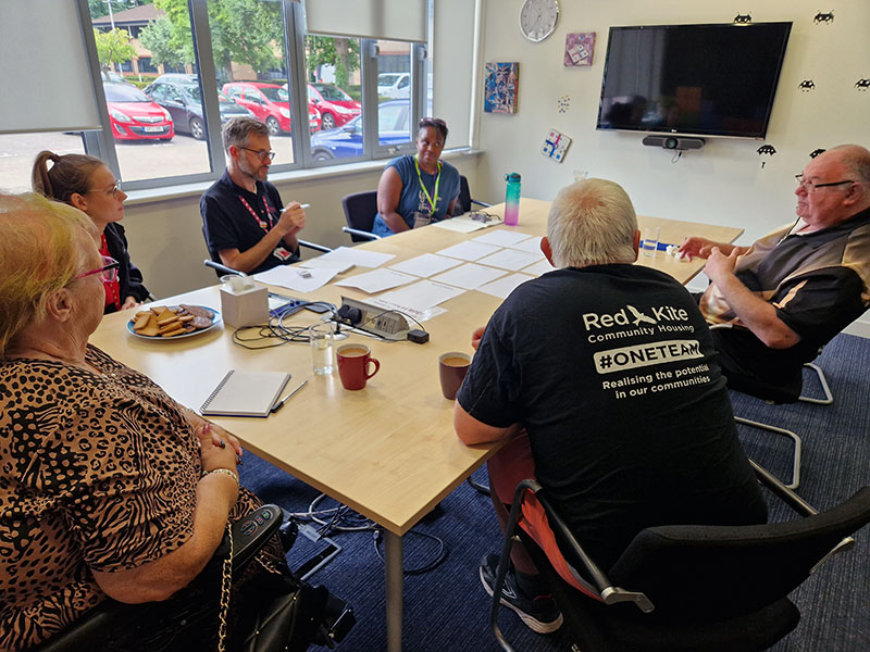 Tenant Volunteers and Communications Team members sitting round the table