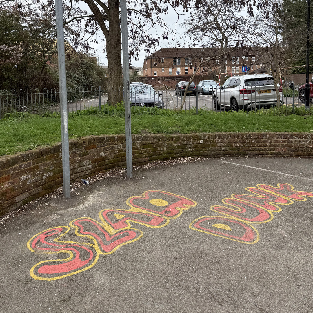 Graffiti Style Painted Writing On The Floor Which Says 'Slam Dunk'