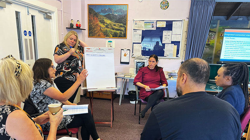 Picture of tenant volunteers at RRT Away Day discussing the agenda in small groups.