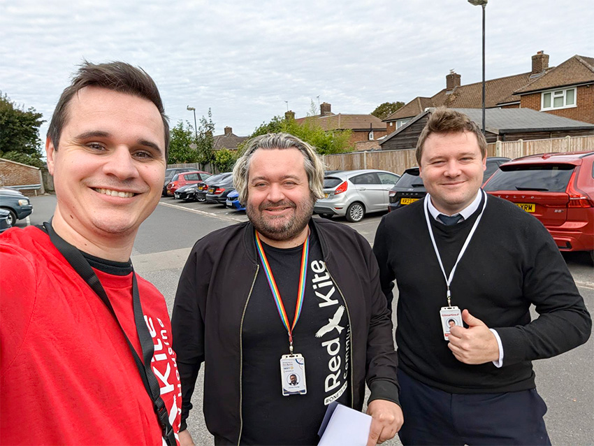 Members of staff smiling whilst taking a selfie outside