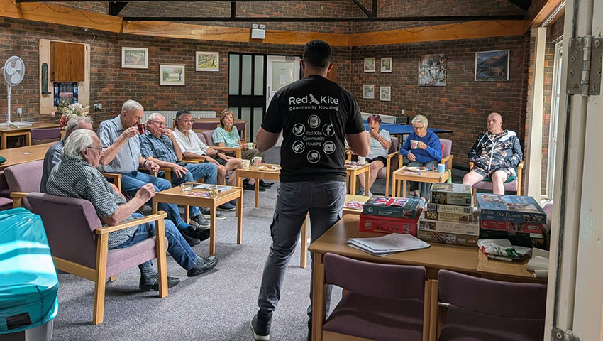 A Red Kite member of staff running a quiz at a sheltered housing scheme