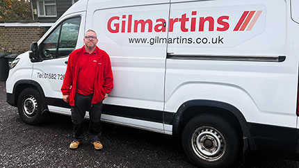 James, a Gilmartins operative, standing beside his van