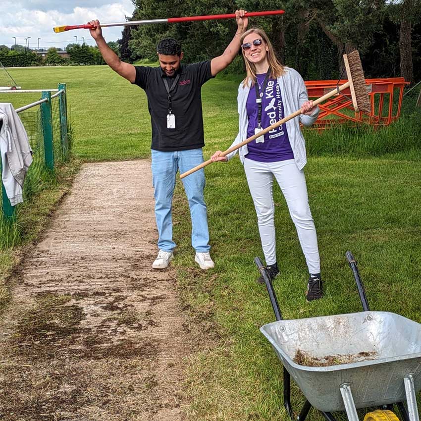 Two Red Kite staff members helping out at Holmer Green Football Club