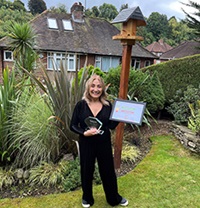 Best Kept garden winner with her certificate