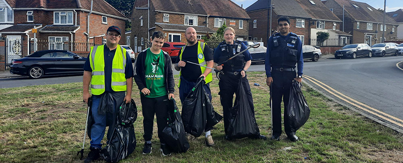 A group shot of 5 litter pickers holding bin bags at Castlefield