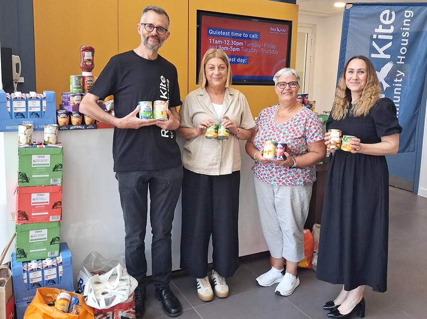 Red Kite Staff Holding Food Donations