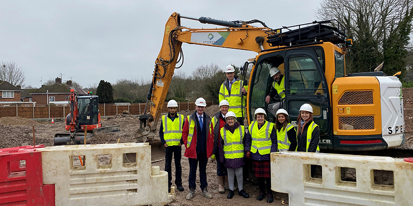 Members of our development panel next to a digger, at Queensmead construction site