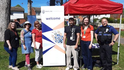 People smiling for a group picture at a community event in Marlow