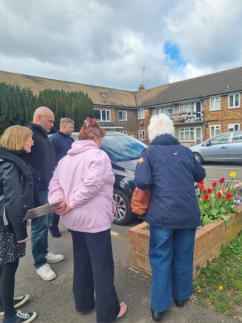 Staff and tenants looking at flowers together