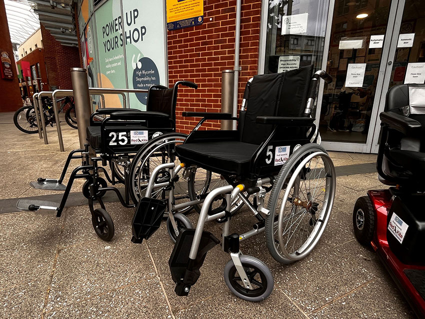 A mobility scooter and two wheelchairs outside Shopmobility High Wycombe in the Eden shopping centre, High Wycombe