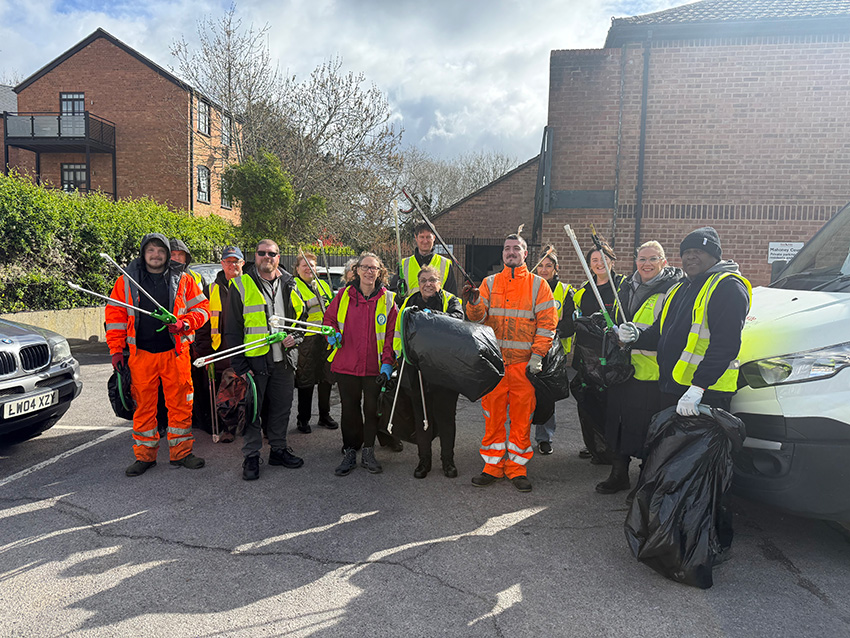 A group photo of Red Kite, John O'Conner and Sasse colleagues with litter pickers and bin bags