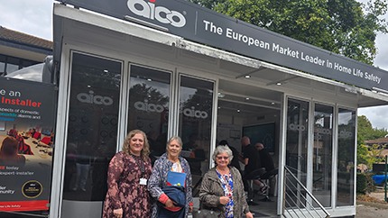 A member of Red Kite staff with two tenant volunteers visiting the Aico Roadshow Trailer