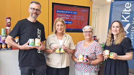 Staff With One Can Donation In Office