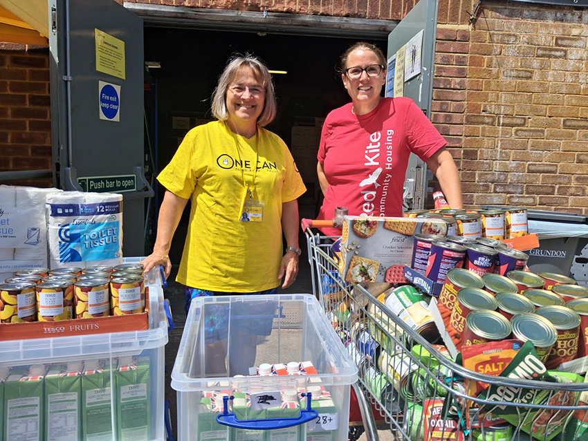 Red Kite Member Of Staff With One Can Trust Member Of Staff Next To Donations
