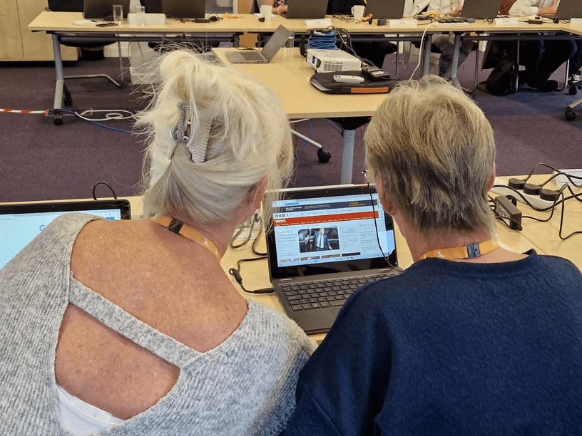 A training session in progress, with two tenants using a laptop