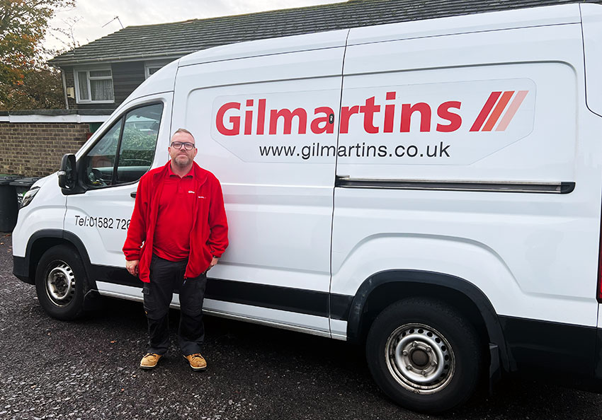 James, a Gilmartins operative, standing beside his van