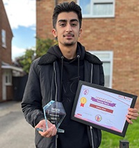 Young hero standing with his medal and certificate