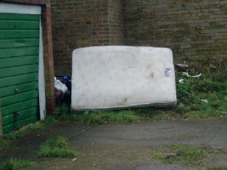 Garage areas have extensive build-up of litter and debris. Bulk waste has not been removed and there is evidence of hazardous materials.